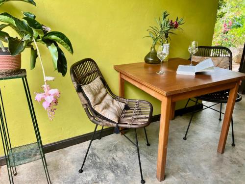 a wooden table with two chairs and a table with wine glasses at The Octopus Tropical Oasis in Sint Michiel
