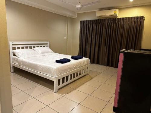 a bedroom with a white bed and a window at Home Sweet Home 3 in Pattaya South