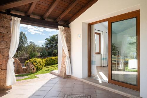 an entrance to a house with a large glass door at Residence Solaria in Budoni