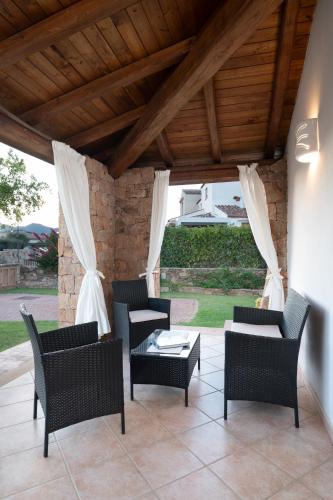 a patio with chairs and a table on a patio at Residence Solaria in Budoni