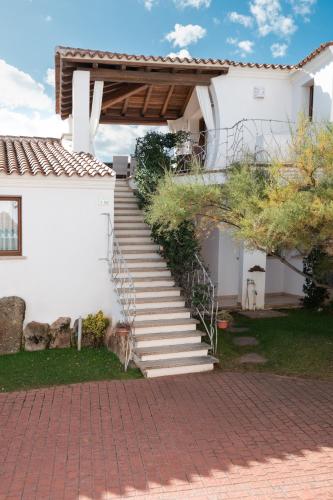 a set of stairs leading to a white house at Residence Solaria in Budoni