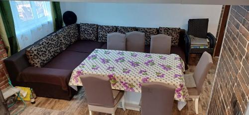 a room with a table and chairs and a couch at Cabana Sponsoru'și Baroana in Aiudu de Sus