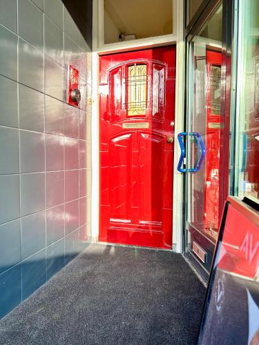 a red door on a building with a window at Leiden City Centre Canal View or Terrace View Apartments in Leiden