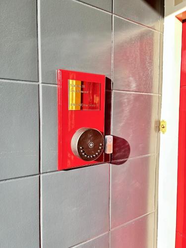 a red switch on a tiled wall at Leiden City Centre Canal View or Terrace View Apartments in Leiden