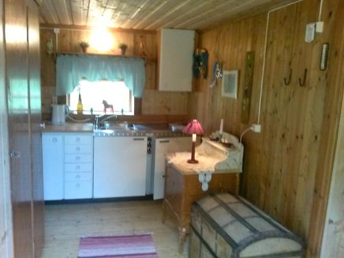 a kitchen with a table with a candle on it at The hunters-lodge in Ludvika