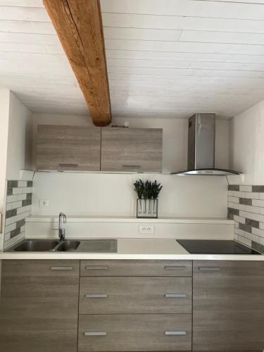 a kitchen with a sink and a counter top at Gite au cœur des vignes in Béziers