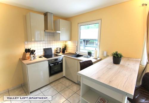 a kitchen with yellow walls and a wooden counter top at Valley Loft Apartment by Aachen-Herzogenrath in Herzogenrath