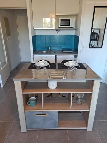 une cuisine avec un comptoir et des lunettes dans l'établissement studio proche Narbonne centre, à Narbonne