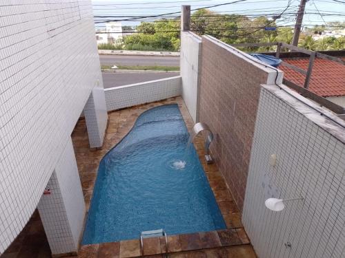 a small swimming pool on the balcony of a building at PONTA NEGRA FLAT APART in Natal