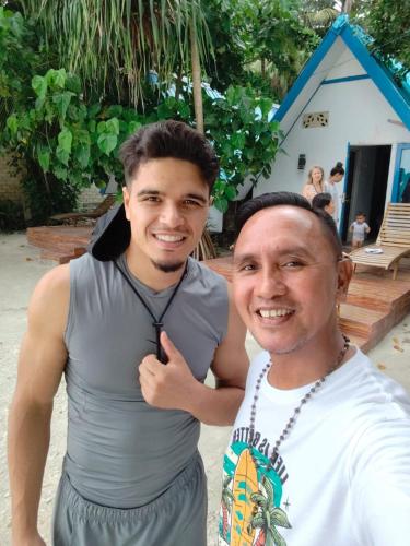 two men are standing next to each other at Tria Maria Cottage in Ngurblut