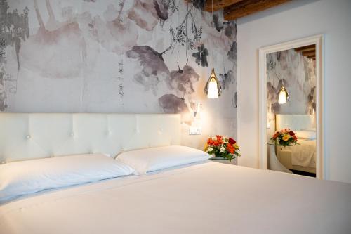 Postel nebo postele na pokoji v ubytování Hermes Venice