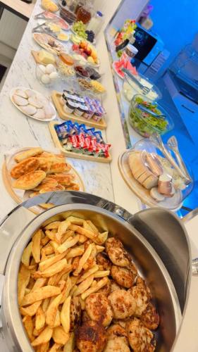 a table topped with a pot of food and snacks at Qadim Hotel in Samarkand