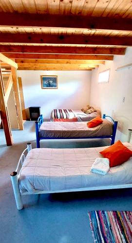 a bedroom with two beds in a room at Tres Piquillines in Puerto Madryn