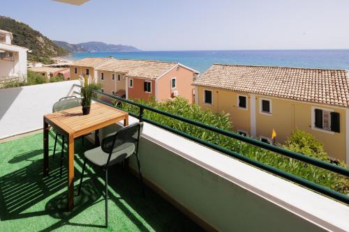 a balcony with a table and a view of the ocean at Coastal Bliss Apartments in Glyfada