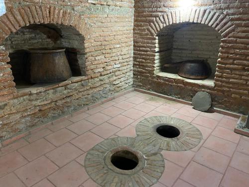 a brick oven with a pot inside of it at Vino Vista in Tʼelavi