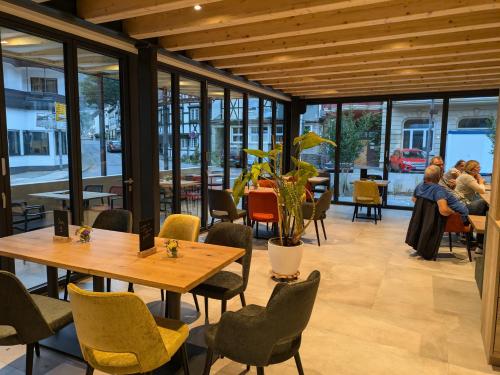 a restaurant with wooden ceilings and tables and chairs at Haus Caspari in Altenahr