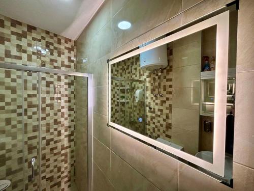 a bathroom with a shower with a glass window at Studio Baščaršija - Sarajevo's prime location in Sarajevo
