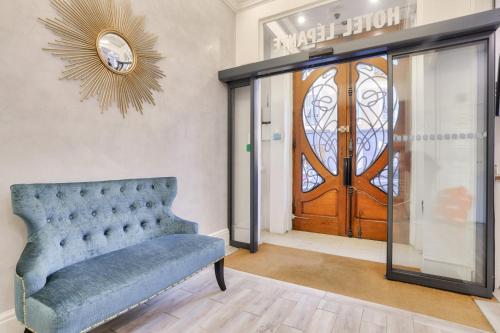 a room with a blue couch and a door at Hotel Lepante in Nice