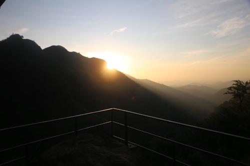 a view of the sun setting over the mountains at Jungle Cave in Ella