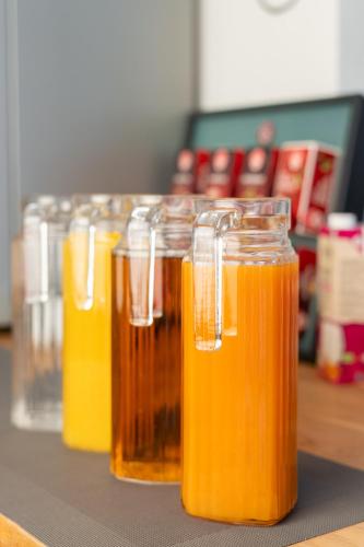 a row of mason jars filled with orange juice at Hotel Laaxerhof in Obertauern
