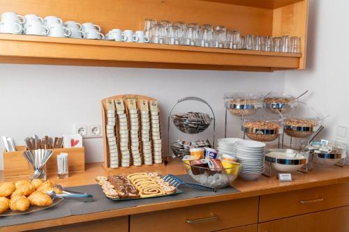a kitchen counter with a bunch of food on it at Hotel Laaxerhof in Obertauern