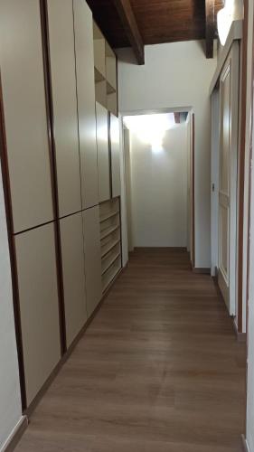 a hallway of an apartment with white walls and wood floors at Guesthouse Il Nido in Sassari