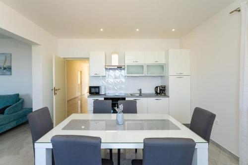 a kitchen and living room with a table and chairs at Holiday home Lorena in Novigrad Dalmatia