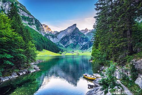 a boat on a river with mountains in the background at NEU renoviert - Bitzi Appenzell – Mit Aussicht in Appenzell