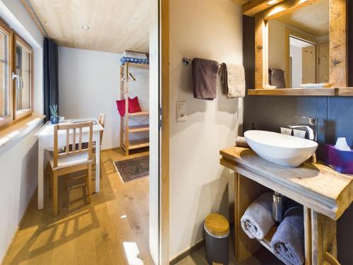 a bathroom with a sink and a mirror at NEU renoviert - Bitzi Appenzell – Mit Aussicht in Appenzell