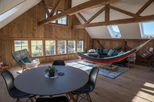 a room with a table and a hammock in it at NEU renoviert - Bitzi Appenzell – Mit Aussicht in Appenzell