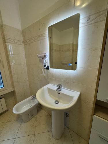 a bathroom with a sink and a mirror at Torre Sole Fiumara in Genova