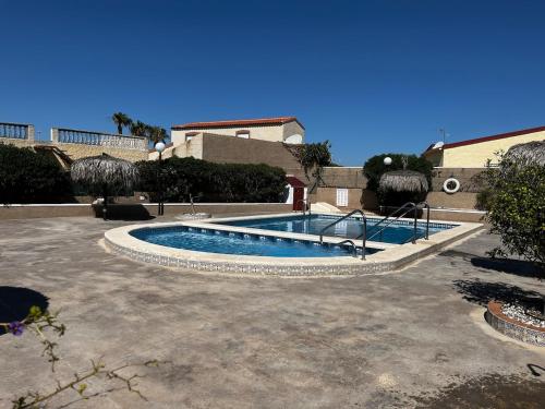 a swimming pool in the middle of a courtyard at Casa ODIE in San Fulgencio