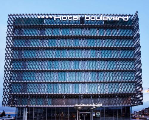a tall building with a sign on top of it at Sercotel Boulevard Vitoria-Gasteiz in Vitoria-Gasteiz