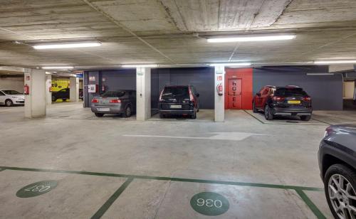 a parking garage with three cars parked in it at Sercotel Boulevard Vitoria-Gasteiz in Vitoria-Gasteiz