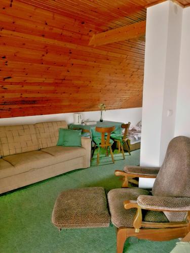 a living room with a couch and a table at Kristóf apartman in Gyenesdiás