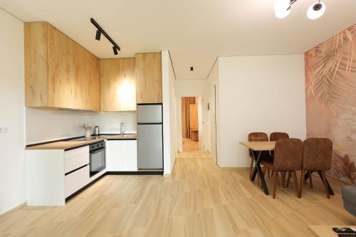 a kitchen and dining room with a table and chairs at SanPietro Vacation Apartments in Durrës