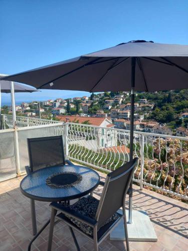 a table and chairs with an umbrella on a patio at Biancaneve in Stomorska