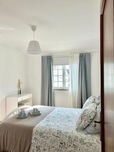 a bedroom with a bed and a window at Sabugal Comfort - Central Castelo in Sabugal