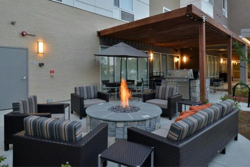 a patio with a table and chairs and a fire pit at TownePlace Suites by Marriott Raleigh Durham Airport Morrisville in Morrisville