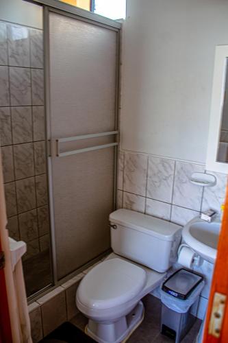 a small bathroom with a toilet and a sink at DEL VALLE HOUSE II in Ica