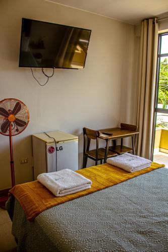 a bedroom with a bed with two towels on it at DEL VALLE HOUSE II in Ica