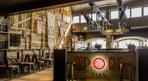 a restaurant with a bar with stools and tables at Mobile Homes Danijela in Amadria Park Trogir in Seget Vranjica