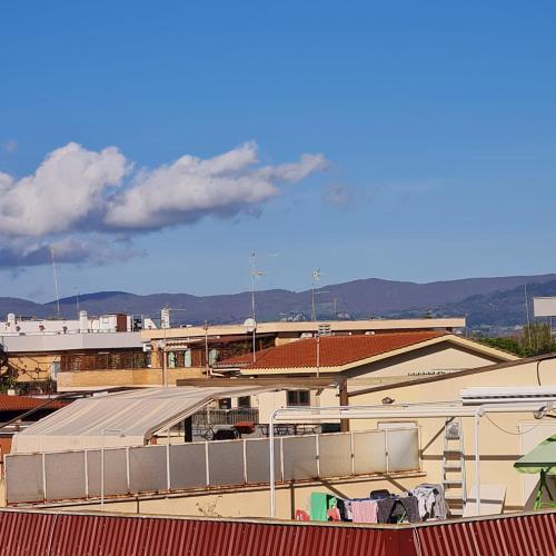a view of roofs of buildings with mountains in the background at Grace's Home in Ladispoli
