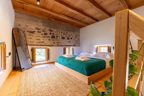 a bedroom with a green bed in a room at Olivetta ,Traditional stone house in Kos Town