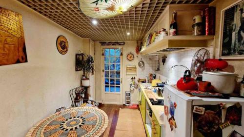 a kitchen with a stove and a counter top at Green house, cosy garden Paris in Alfortville