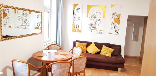 a living room with a table and a couch at ELENA flat Tulpe Duisburg Zentrum in Duisburg