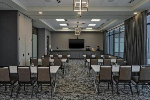 a conference room with tables and chairs and a projection screen at Element Colorado Springs Downtown in Colorado Springs