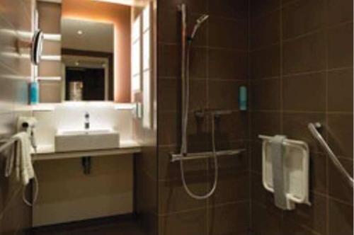 a bathroom with a shower and a sink at Terre de Provence Hôtel & Spa in Le Pontet