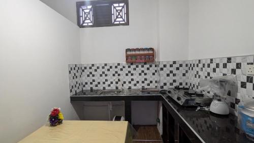 a kitchen with a sink and a counter top at Villa Dewdrops in Hikkaduwa