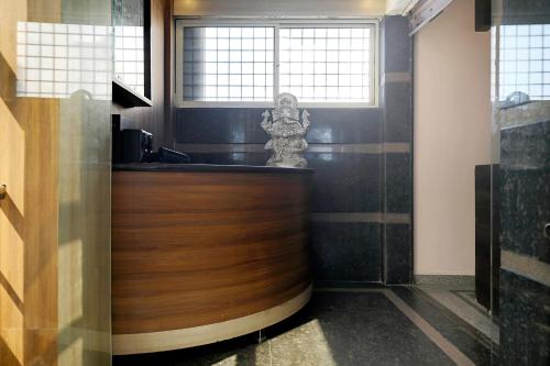 a kitchen with a wooden counter and a window at Hotel O HOTEL UTSAV PALACE in Bengaluru